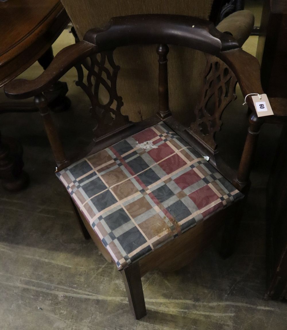 A George III mahogany corner elbow commode chair